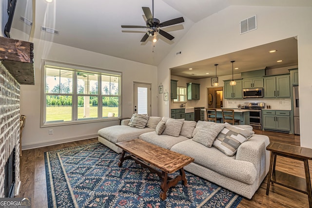 living room with vaulted ceiling, ceiling fan, sink, and dark hardwood / wood-style floors