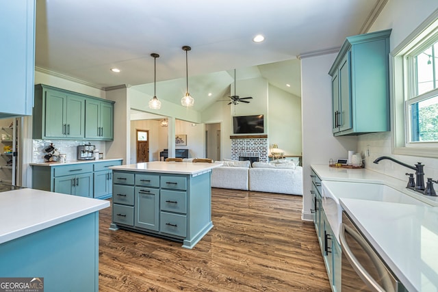 kitchen with ceiling fan, a brick fireplace, stainless steel dishwasher, vaulted ceiling, and decorative backsplash