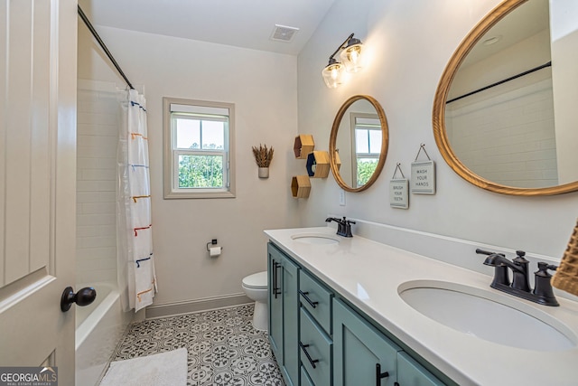 full bathroom with tile patterned flooring, vanity, toilet, and shower / bath combo with shower curtain