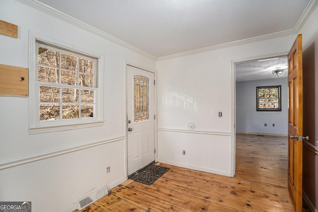 foyer featuring hardwood / wood-style floors and ornamental molding