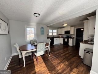 dining area with dark hardwood / wood-style flooring and a textured ceiling