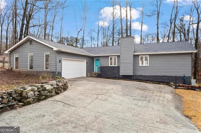 ranch-style house featuring a garage