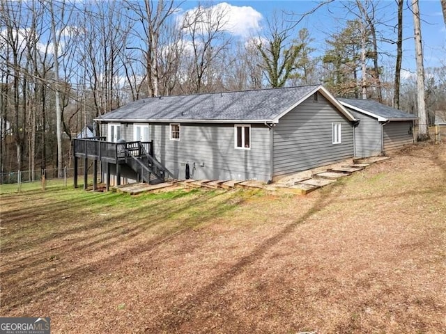 view of home's exterior featuring a deck and a lawn