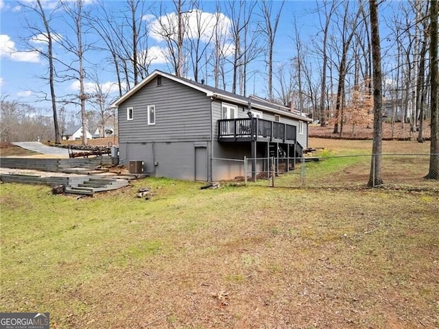 exterior space featuring central air condition unit, a yard, and a deck