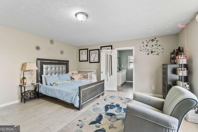 bedroom featuring light hardwood / wood-style floors and a textured ceiling