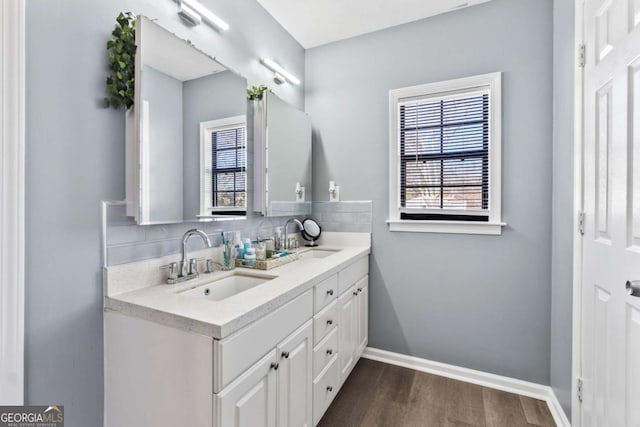 bathroom featuring tasteful backsplash, hardwood / wood-style floors, and vanity