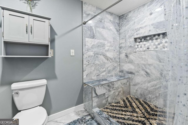 bathroom with toilet and a tile shower