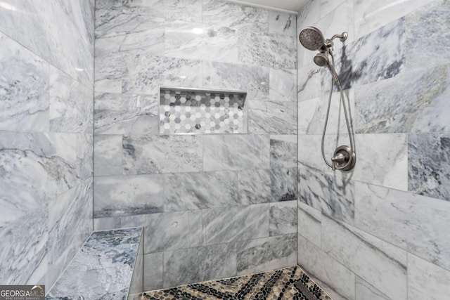 bathroom with a tile shower