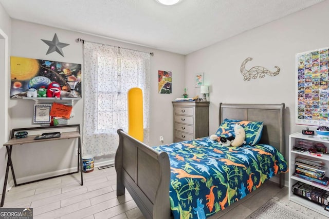 bedroom featuring hardwood / wood-style flooring and multiple windows