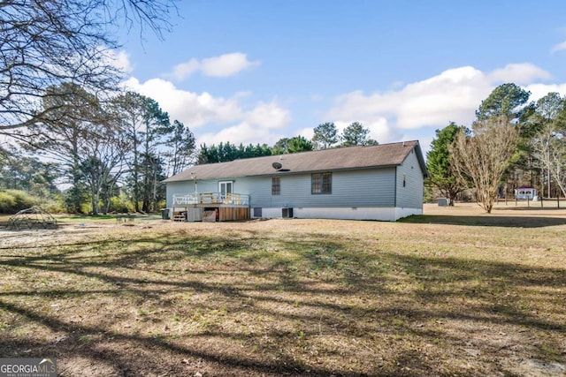 rear view of property featuring a lawn