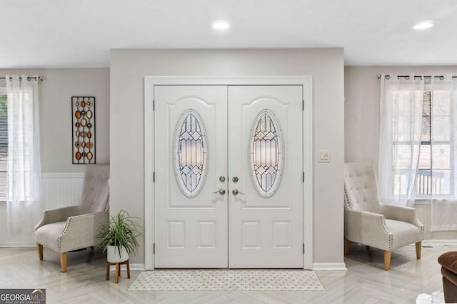 entrance foyer with light parquet flooring and a healthy amount of sunlight