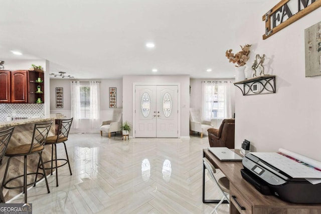 foyer featuring light parquet floors and a healthy amount of sunlight