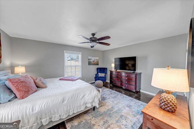 bedroom featuring ceiling fan and dark hardwood / wood-style floors