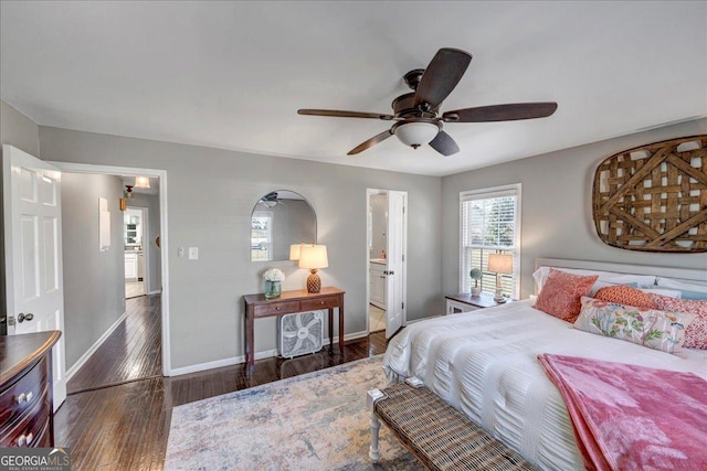 bedroom featuring ceiling fan, dark wood-type flooring, and ensuite bath