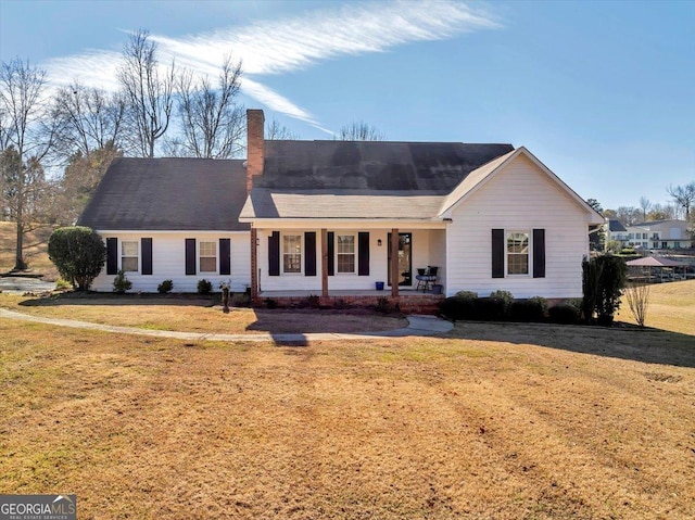 ranch-style home with a porch and a front yard