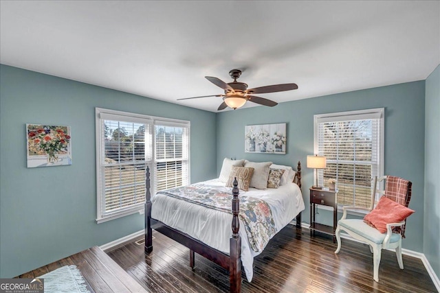 bedroom featuring multiple windows, ceiling fan, and dark wood-type flooring