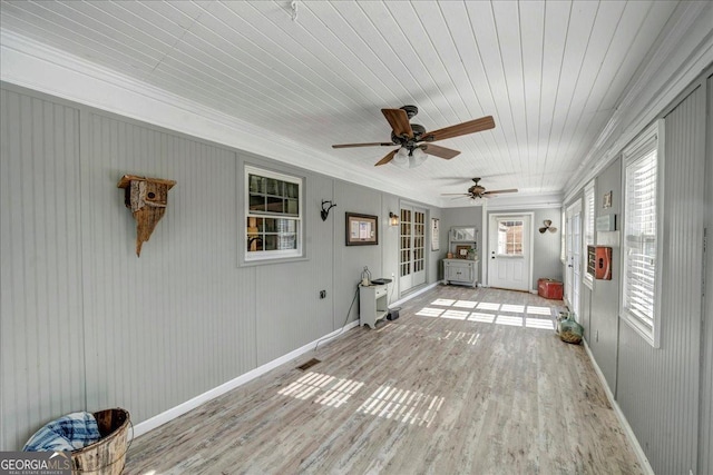 unfurnished sunroom with ceiling fan and wood ceiling