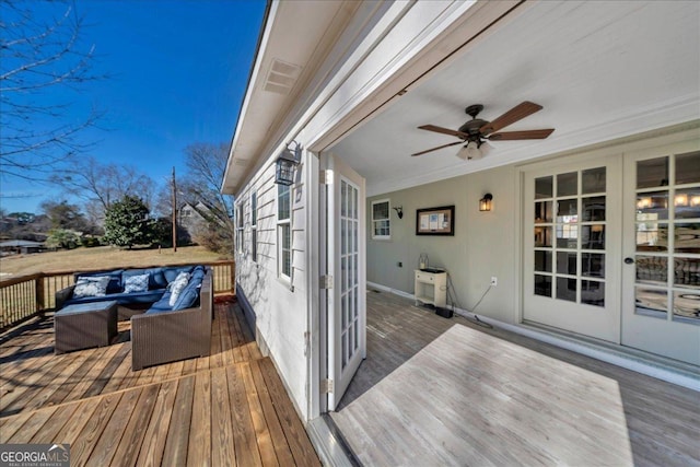 wooden terrace featuring ceiling fan and an outdoor hangout area