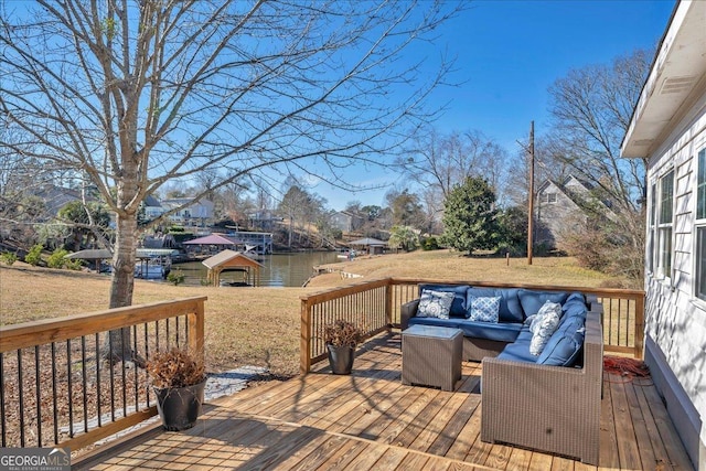 wooden deck featuring an outdoor living space, a yard, and a water view