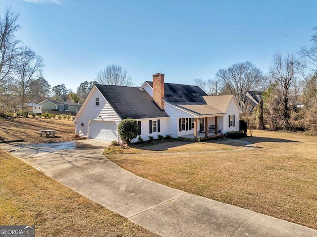 view of front of home with a porch, a garage, and a front lawn