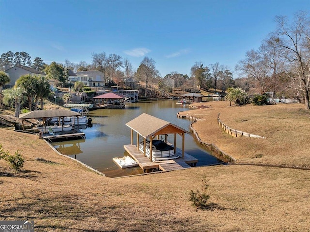 view of dock featuring a lawn and a water view