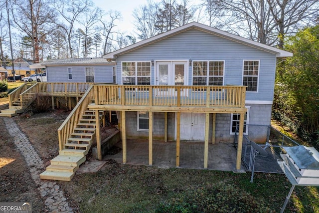 rear view of property featuring a patio and a deck