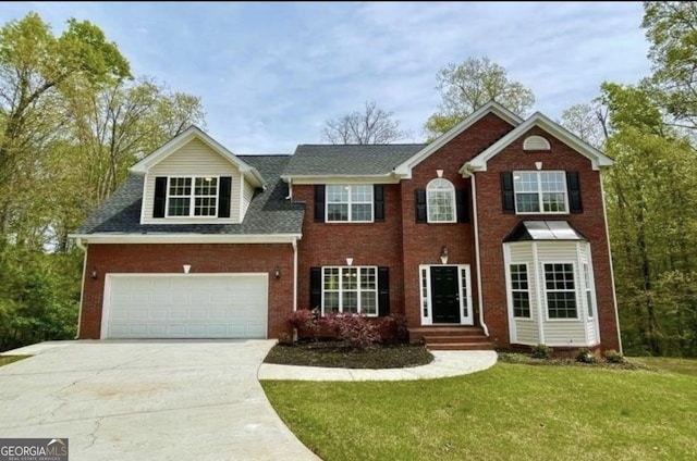 view of front of property with a garage and a front yard