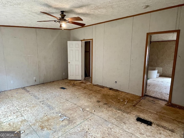 interior space featuring ornamental molding, a textured ceiling, and ceiling fan