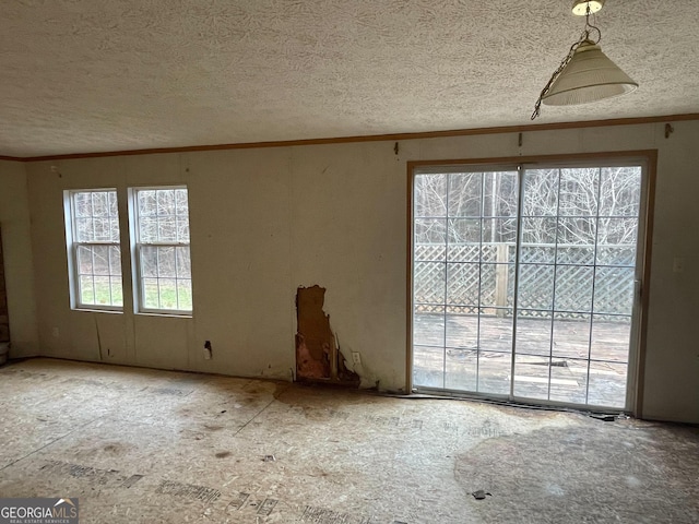 unfurnished room with a textured ceiling