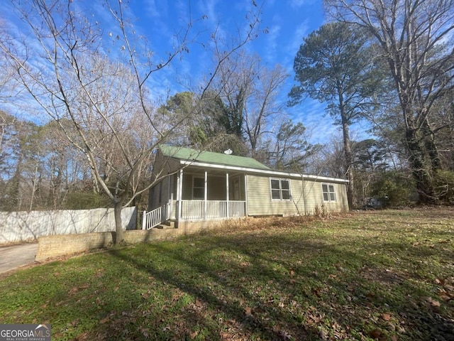 view of front of house with a front lawn and a porch