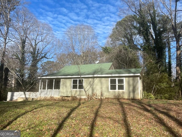 exterior space with a porch and a front lawn