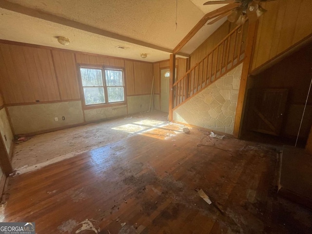 interior space featuring ceiling fan and a textured ceiling