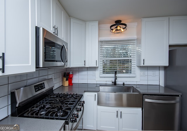 kitchen with sink, white cabinets, and stainless steel appliances