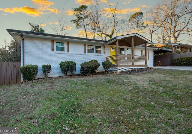 ranch-style home featuring a lawn