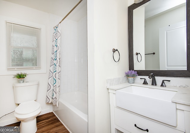 full bathroom with shower / tub combo, vanity, toilet, and hardwood / wood-style floors