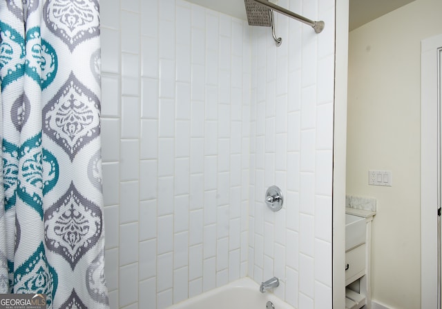 bathroom featuring shower / bathtub combination with curtain and vanity