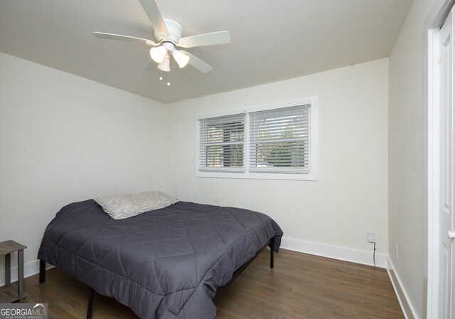 bedroom featuring ceiling fan and dark hardwood / wood-style floors