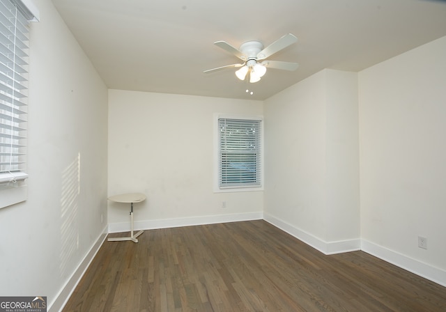 unfurnished room featuring ceiling fan and dark wood-type flooring