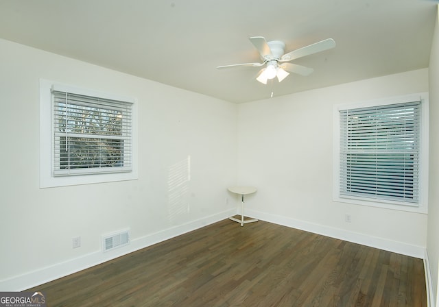 spare room with dark hardwood / wood-style floors and ceiling fan