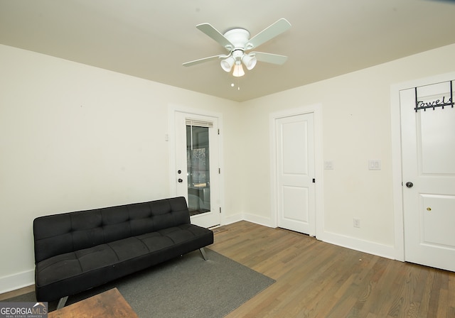 sitting room featuring ceiling fan and dark wood-type flooring