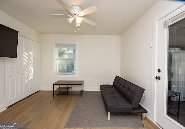 sitting room featuring wood-type flooring and ceiling fan