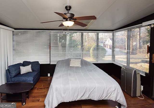 bedroom featuring ceiling fan, dark hardwood / wood-style floors, and lofted ceiling