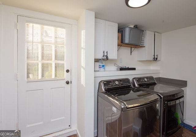 laundry room featuring cabinets, separate washer and dryer, and a wealth of natural light