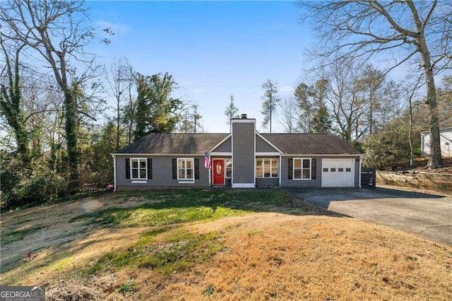 ranch-style home featuring a front yard and a garage