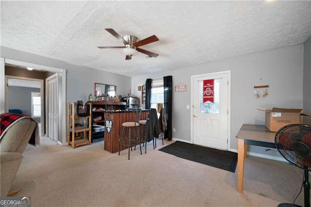 interior space with a textured ceiling, plenty of natural light, and ceiling fan