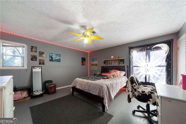 bedroom with ceiling fan, concrete floors, and a textured ceiling