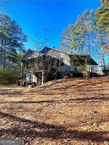 view of property exterior with a sunroom