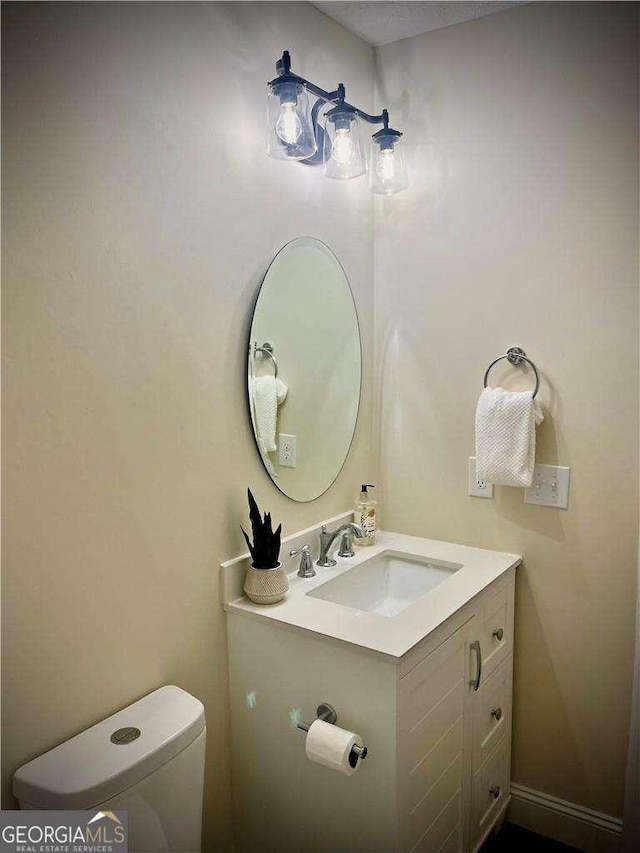 bathroom featuring vanity and toilet