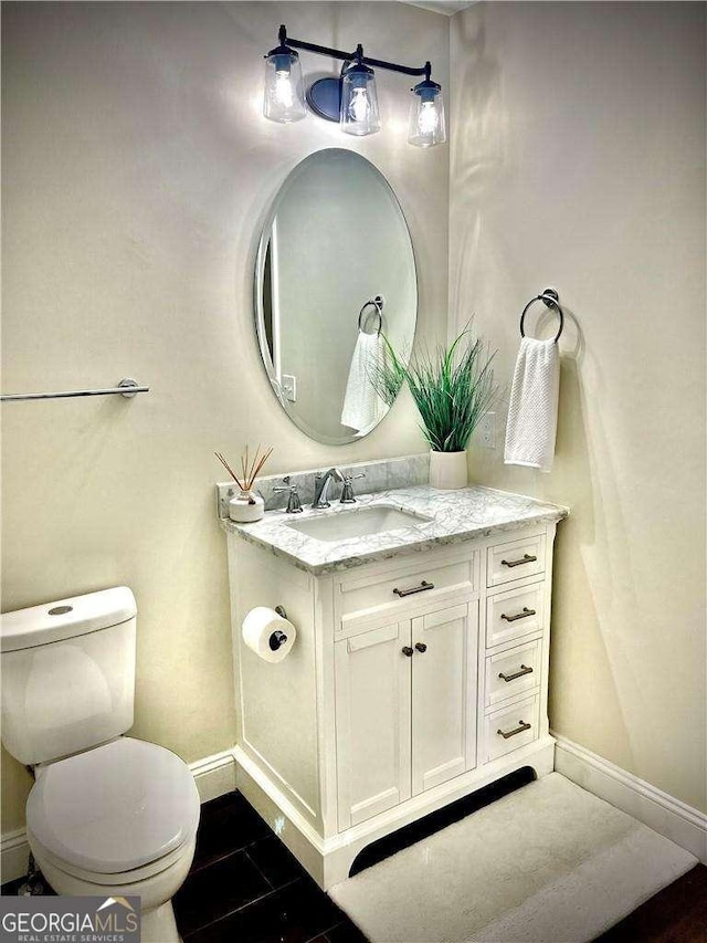 bathroom featuring vanity and toilet