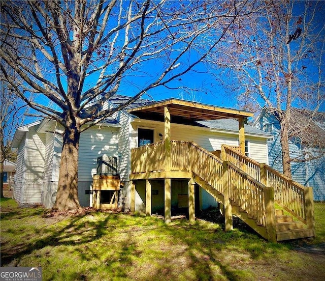 back of house with a yard and a deck